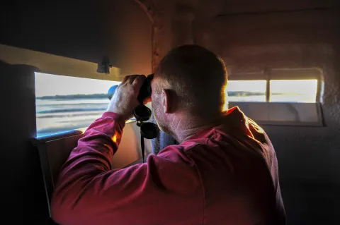A biologist monitoring whooping cranes