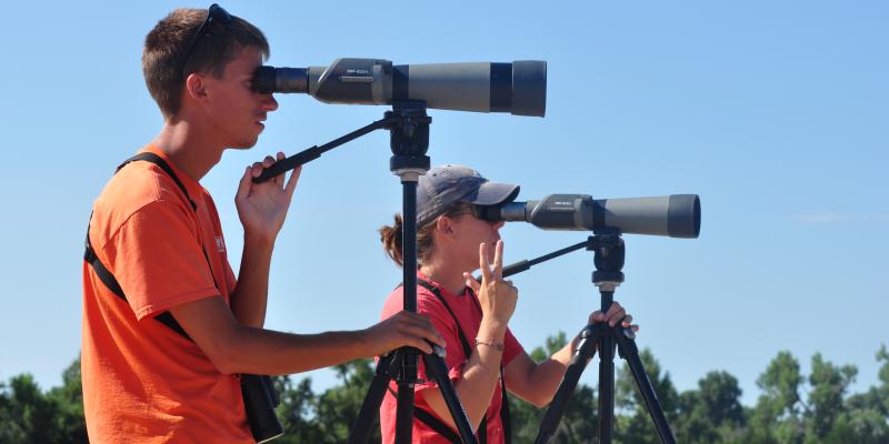 Platte River birders looking through spotting scopes